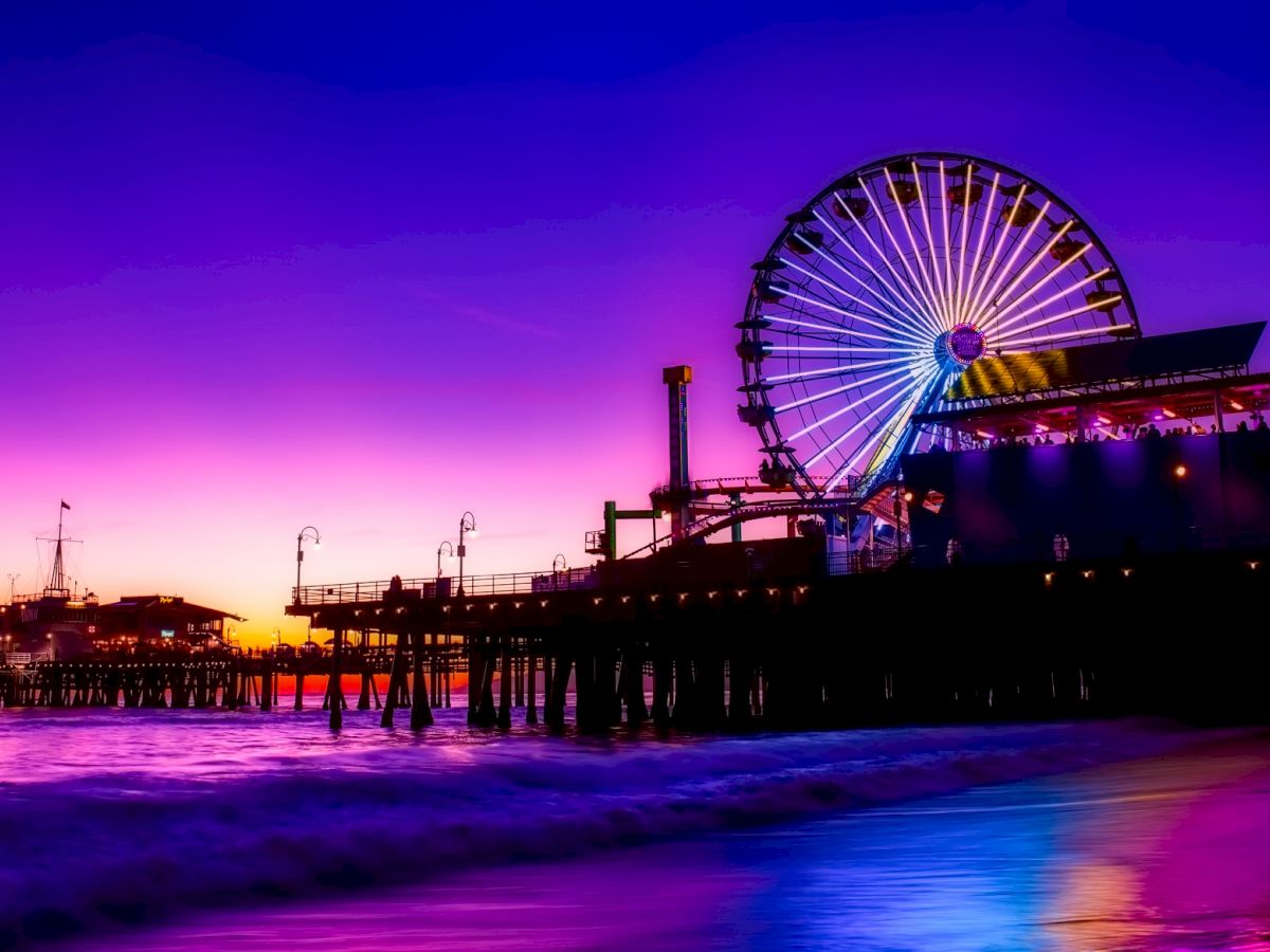 A vibrant sunset scene at a pier with a ferris wheel and carnival lights reflecting on the water, creating a stunning and colorful silhouette.